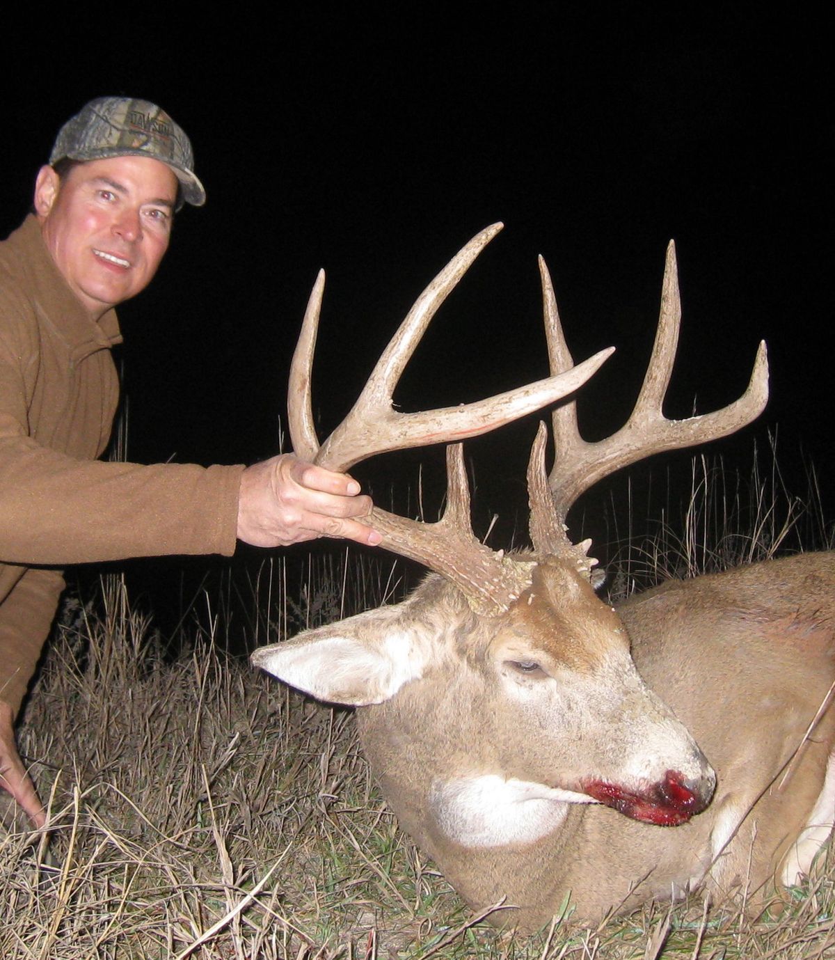 Hunter with a mature Kansas whitetail buck